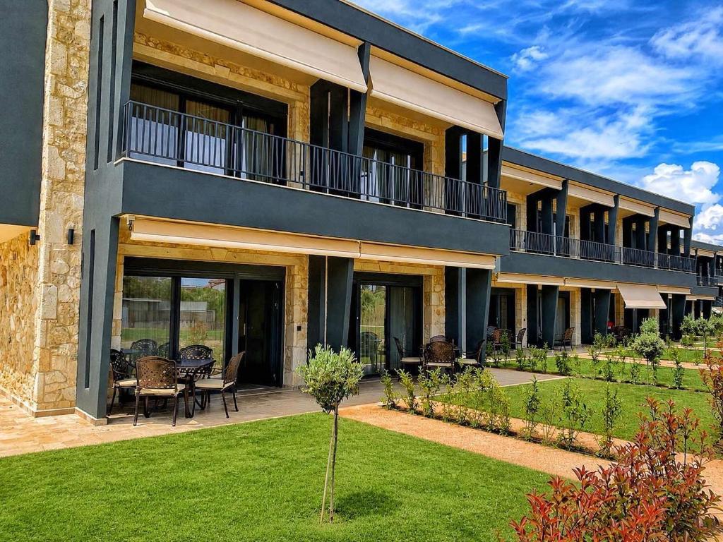 a large building with a patio and a lawn at RCR The Stones in Flogita