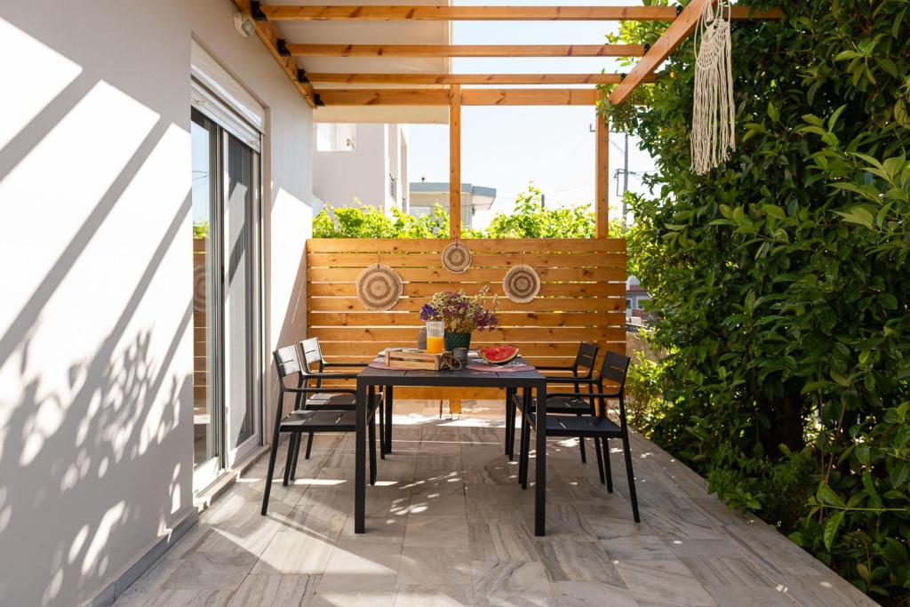 a table and chairs sitting on a patio at Filerimos Nest - Private Countyard in Pastida