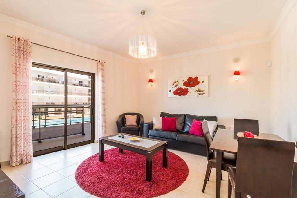 a living room with a couch and a table at Vandalou By ALzira in Albufeira