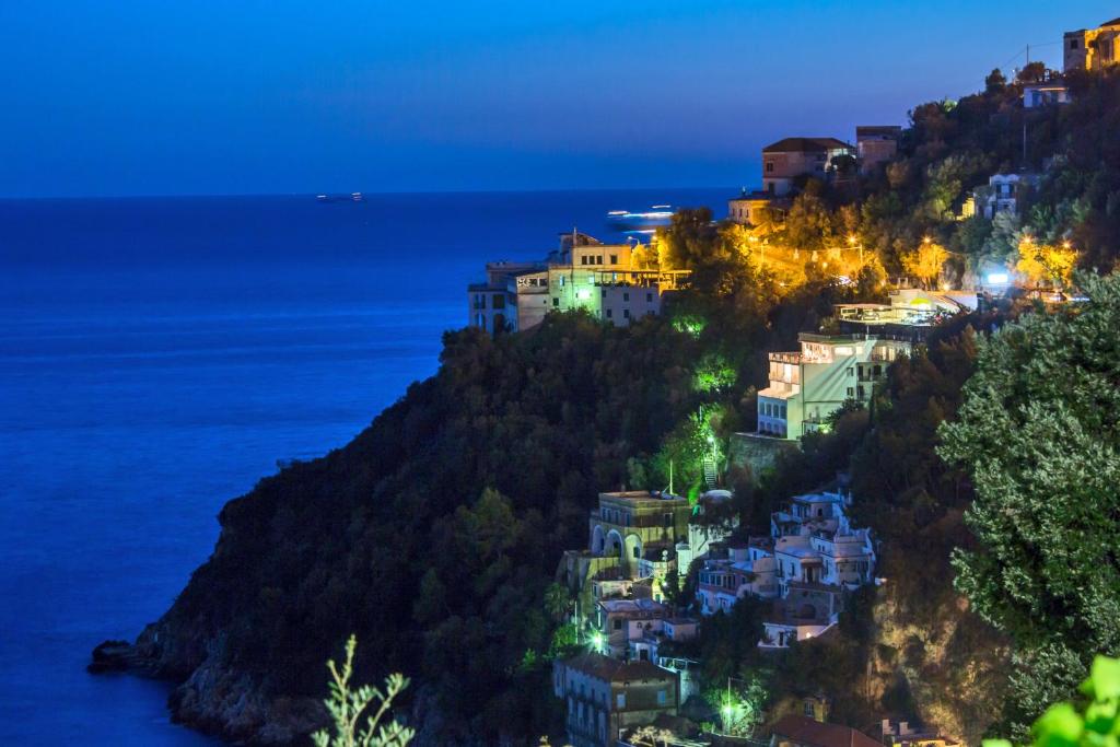 a group of houses on a hill at night at Hotel Le Terrazze in Conca dei Marini
