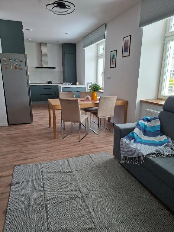 a living room with a couch and a table with chairs at Apartmá 575 in Strakonice