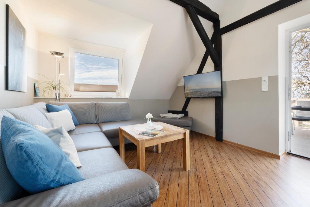 a living room with a couch and a table at Vadersdorf 31 Im Backhaus in Vadersdorf