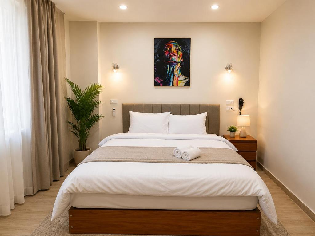 a bedroom with a bed and a painting on the wall at New Hyde Park House Hotel in Alexandria
