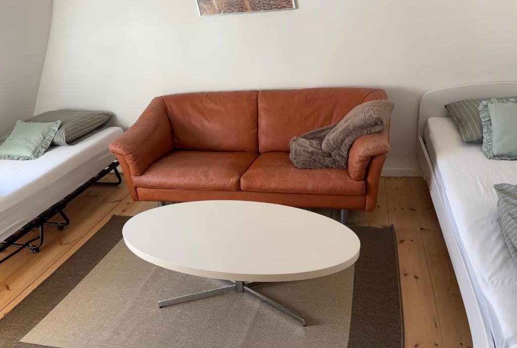 a living room with a couch and a coffee table at Søgården, 3080 Tikøb in Tikøb