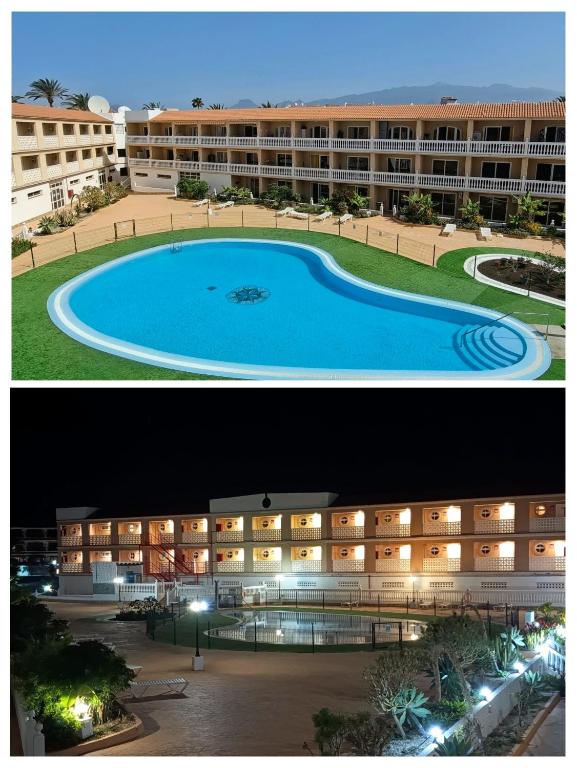 a large building with a swimming pool in front of it at Apartamento ELIDE in Costa Del Silencio