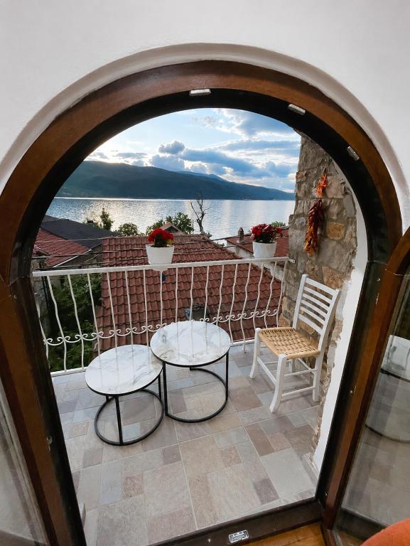 a room with an arched doorway with two tables and a chair at Shegani House in Lin