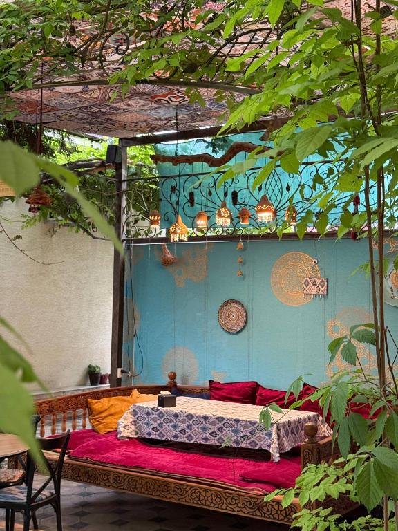 a bedroom with a bed in a room with trees at Zahid Inn in Tashkent