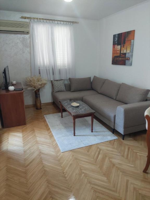 a living room with a couch and a coffee table at Jana apartment 3 in Tivat