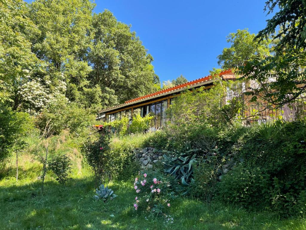 a garden in front of a house with trees at DOMAINE St GEORGES in Mosset