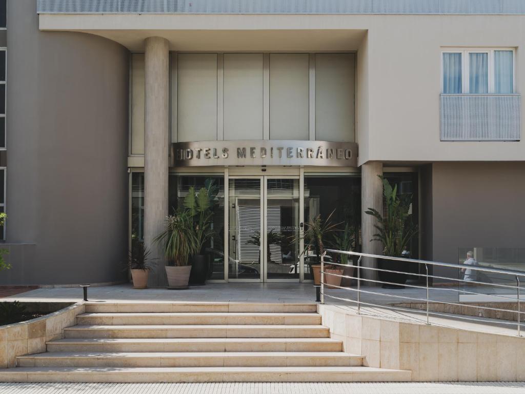 a building with stairs in front of a building at Hotel Mediterráneo in Roses