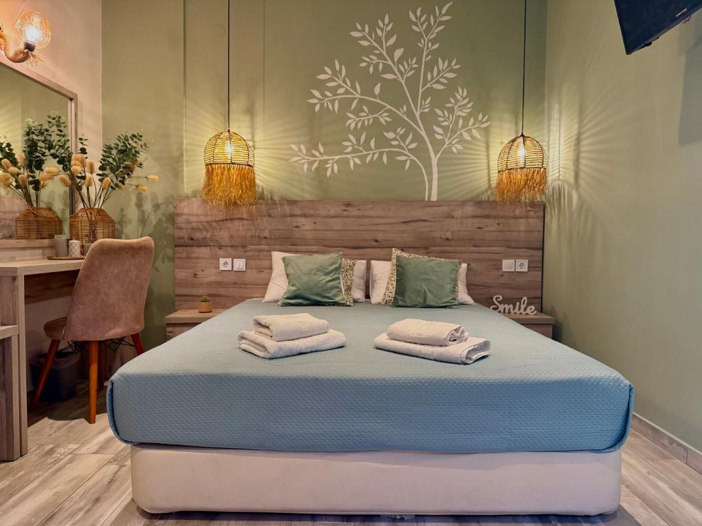 a bedroom with a bed with towels on it at ΑVLI Sarti Studios & Apartments no1 in Sarti