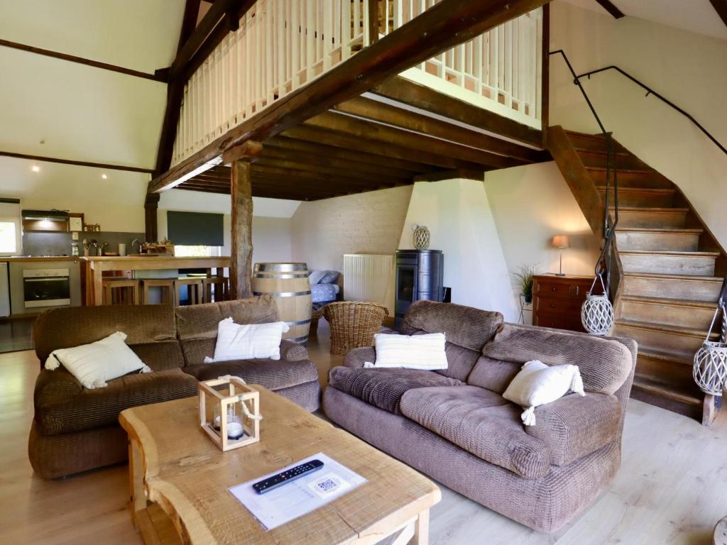 a living room with two couches and a table at Baronheid in Francorchamps