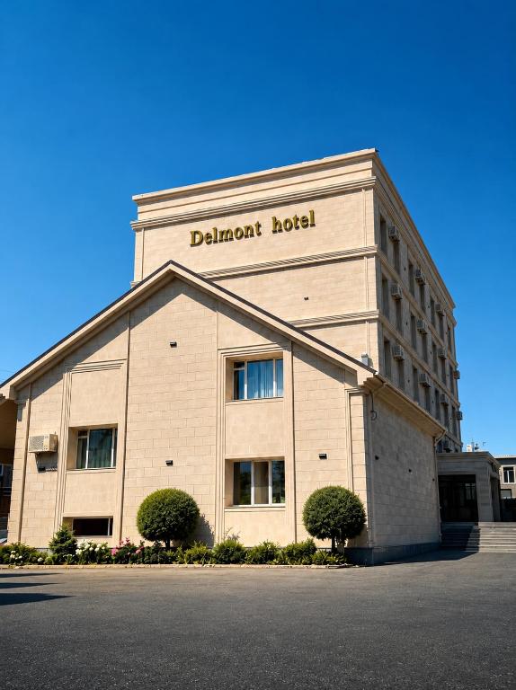 a building with a sign on the front of it at Delmont hotel in Kostanay
