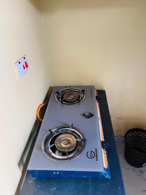 a stove sitting on a table in a room at Fewa studio in Busia