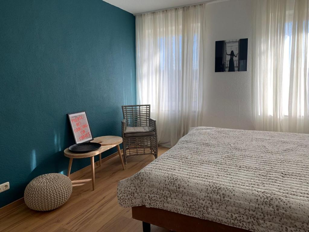 ein Schlafzimmer mit einem Bett, einem Tisch und einem Stuhl in der Unterkunft Boutique-Stay in Eberswalde-Finow