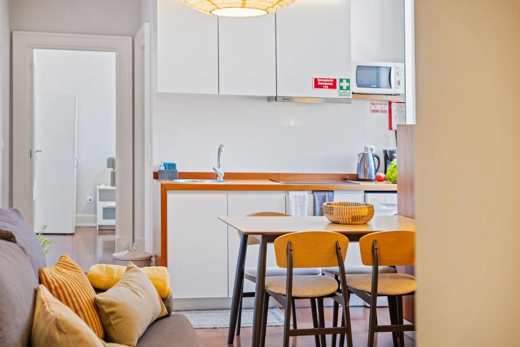 a kitchen with a table and chairs in a room at Hillside - By WeHost in Funchal
