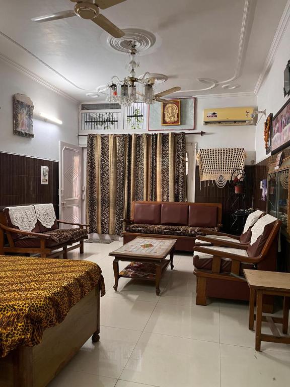 a living room with furniture and a couch in a room at Subhash Chander homestay in Panchkula