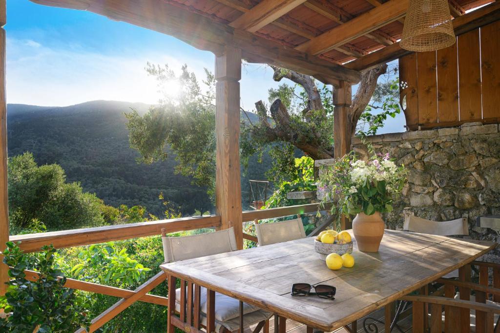 a wooden table with fruit on top of a porch at Eftihia in Katouna