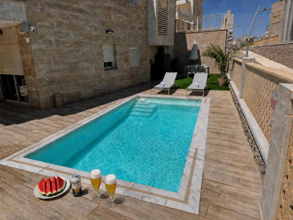 a swimming pool in the backyard of a house at בית נופש - הדקל והים אילת in Eilat