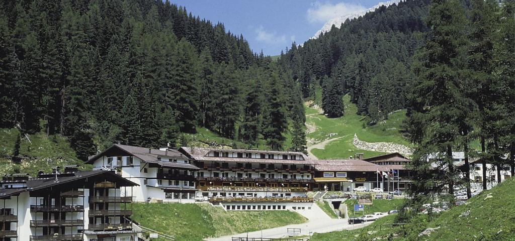 a large building in the middle of a mountain at Sport Hotel Pampeago in Tesero