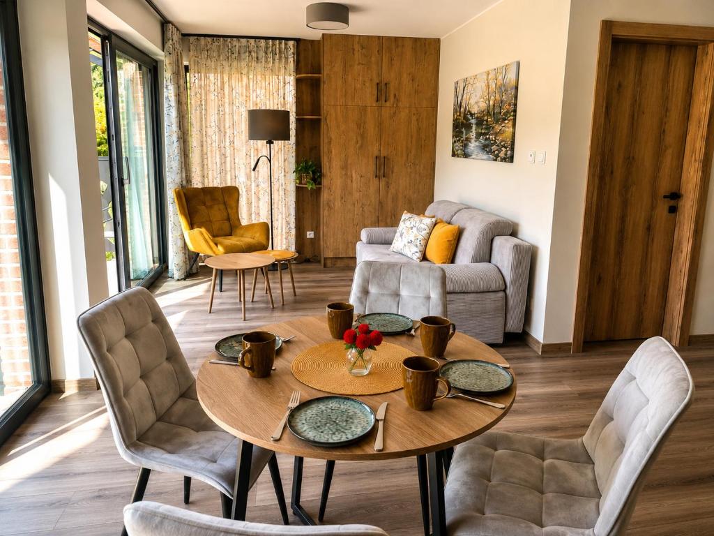 a living room with a table and chairs at Szum Rzeki - Noclegi nad Brdą - Bory Tucholskie in Nadolna Karczma