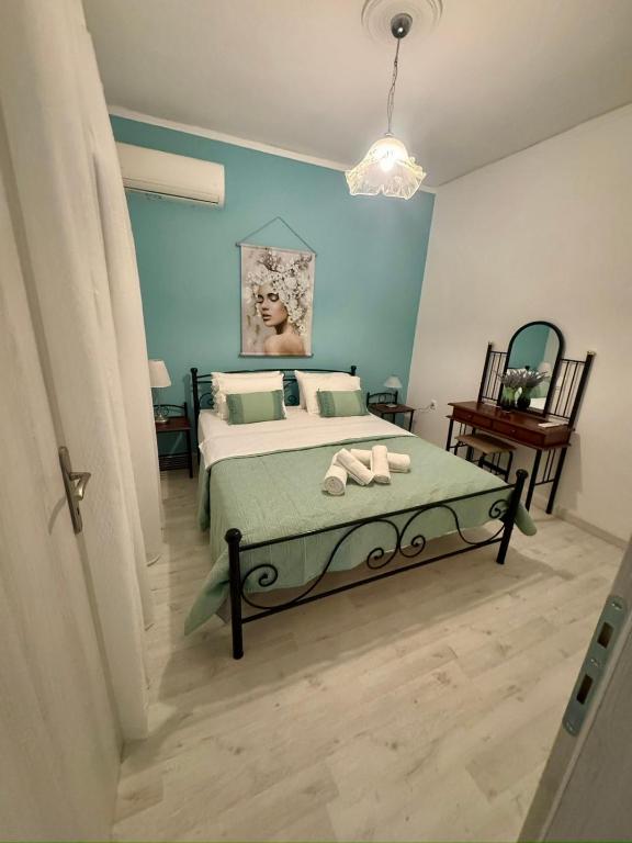 a bedroom with a bed with two towels on it at AnnaPolys House in Kavála