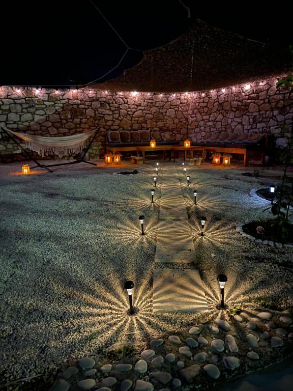 a group of lights on a stone building at night at Little himara 1 in Himare