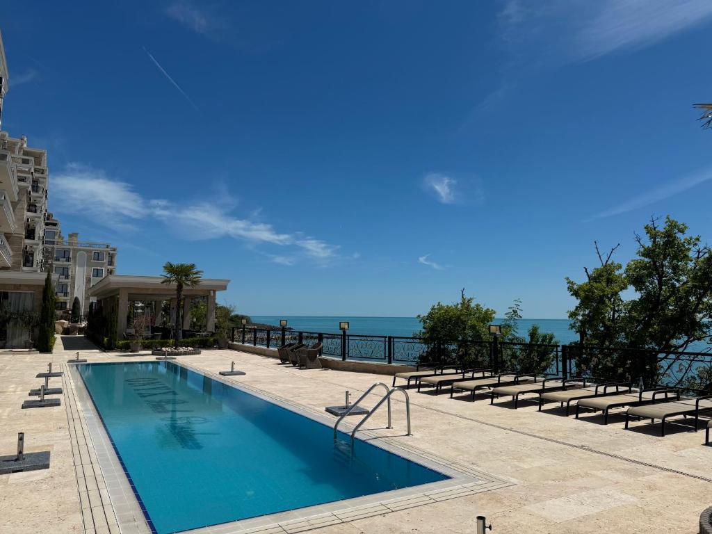 a swimming pool with a view of the ocean at VP Onyx Apartment in Elenite