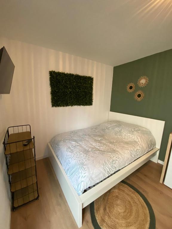 a bedroom with a bed in a room at Au6bis in Givet