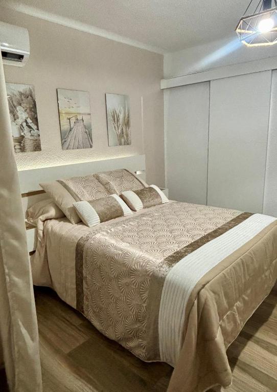 a bedroom with a large bed in a room at SOLyMAR in Garrucha