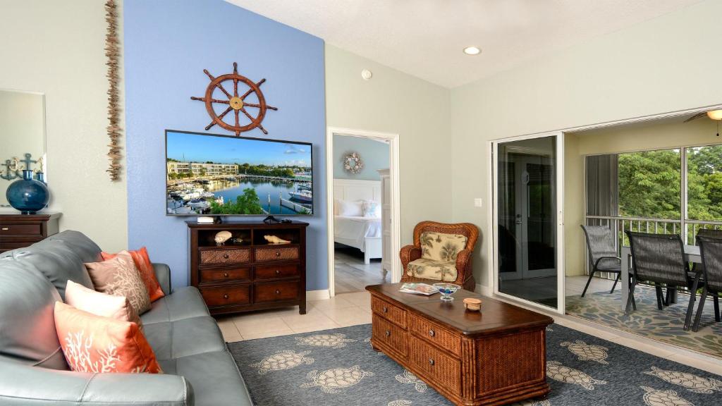 a living room with a couch and a tv at 802 Mariners Club in Key Largo