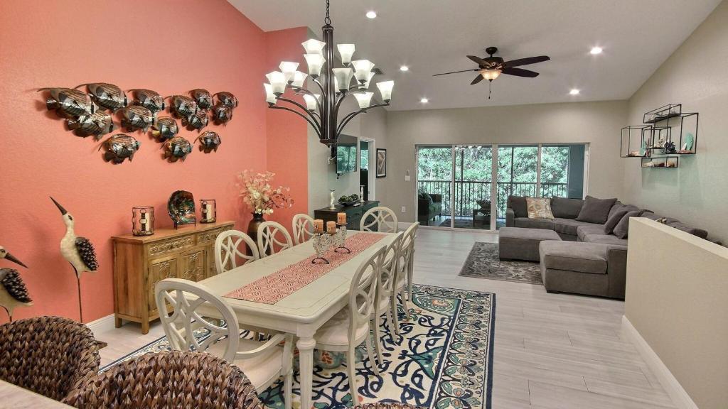 a dining room and living room with a table and chairs at 808 Mariners Club in Key Largo