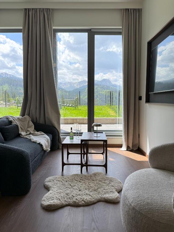 a living room with a couch and a table at Stone Suite Zakopane in Zakopane