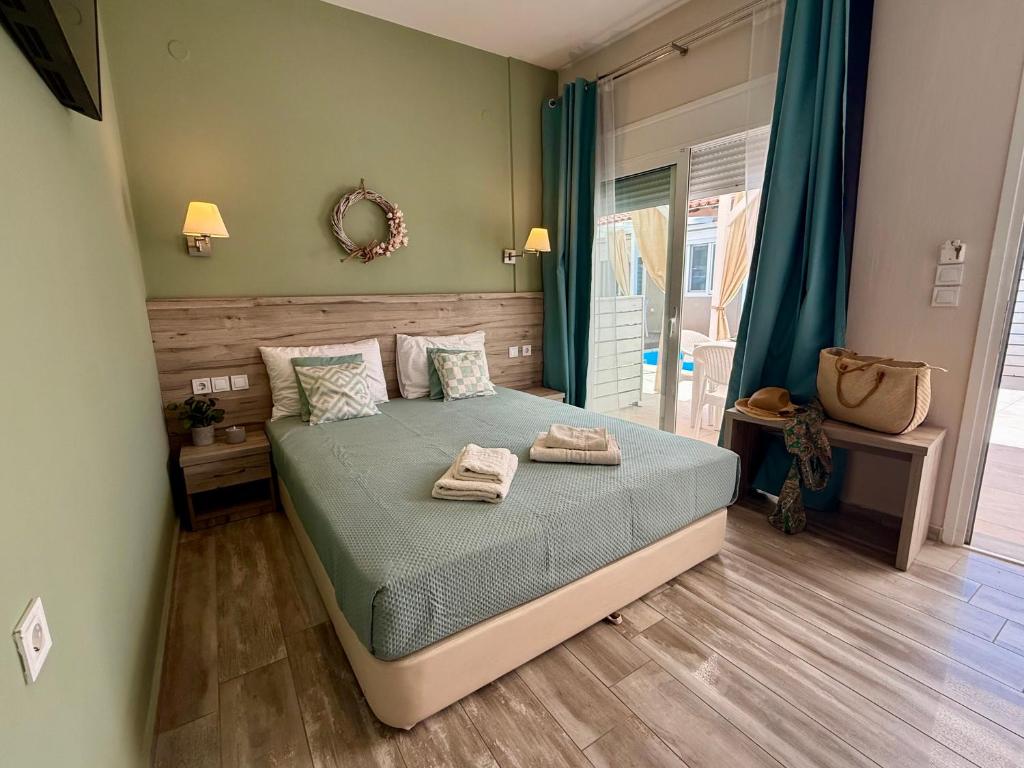 a bedroom with a bed with two towels on it at AVLI Sarti Studios & Apartments no2 in Sarti