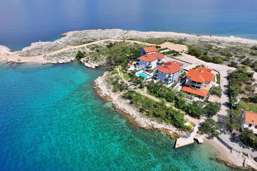 an aerial view of a house on an island in the water at Villas Punta Silo - luxury apartments with pool in Šilo