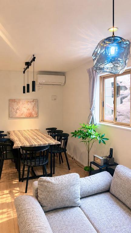 a living room with a table and a couch at Sakura View Nagoya Stay Hub in Nagoya