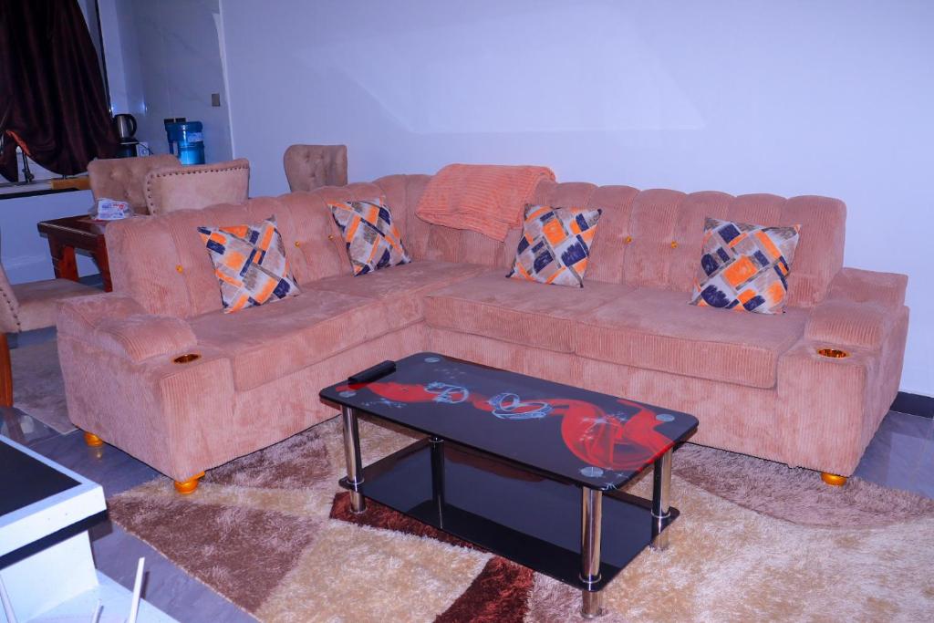 a living room with a couch and a coffee table at Malkia Exquisite Homes in Nairobi
