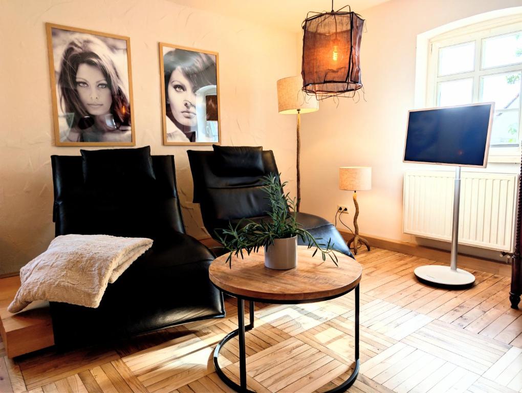 a living room with a black couch and a table at II Bramasole - Sophia L in Spreewitz