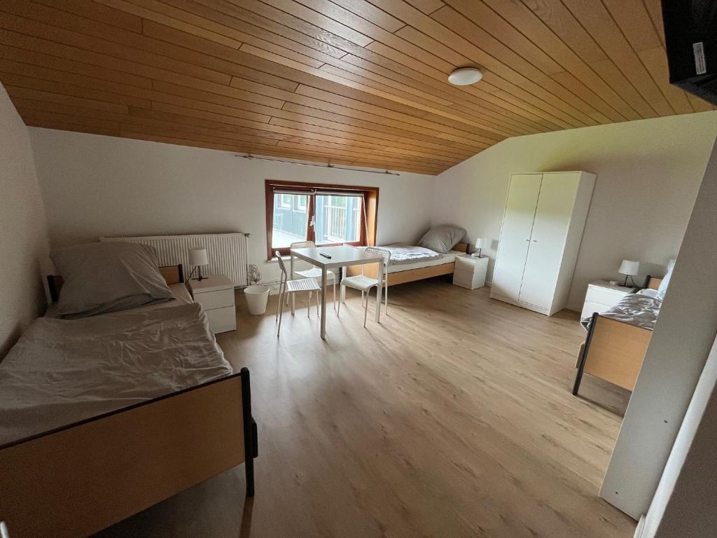 a room with two beds and a table in it at Helles 3 Bett Zimmer in Jerrishoe