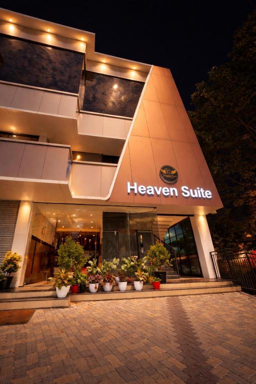 a herezer strike building with potted plants in front of it at Heaven Suite in Kalpetta