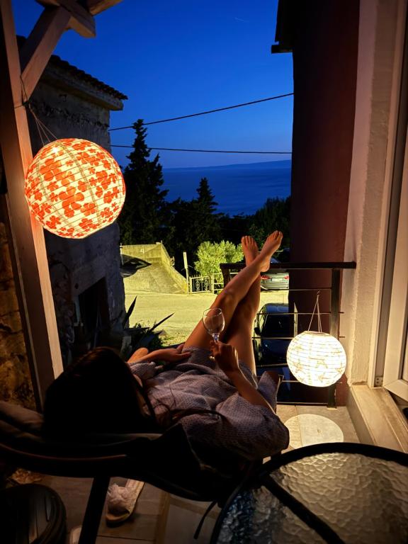 a person laying in a chair on a porch at Agave apartments in Stara Baška