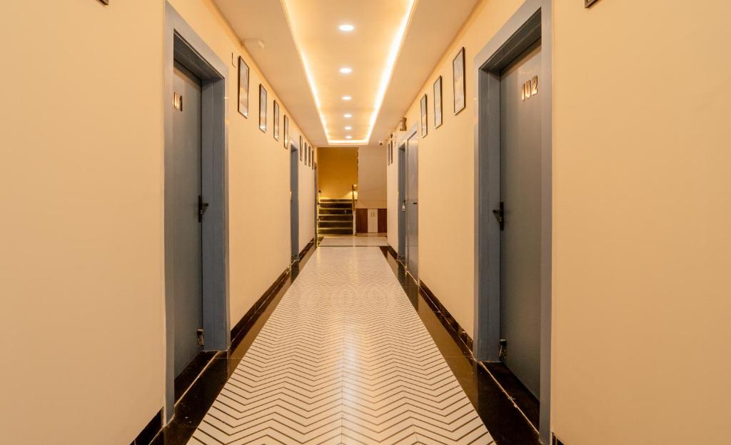 a corridor of a corridor of a building at palm hotel mansarovar in Jaipur