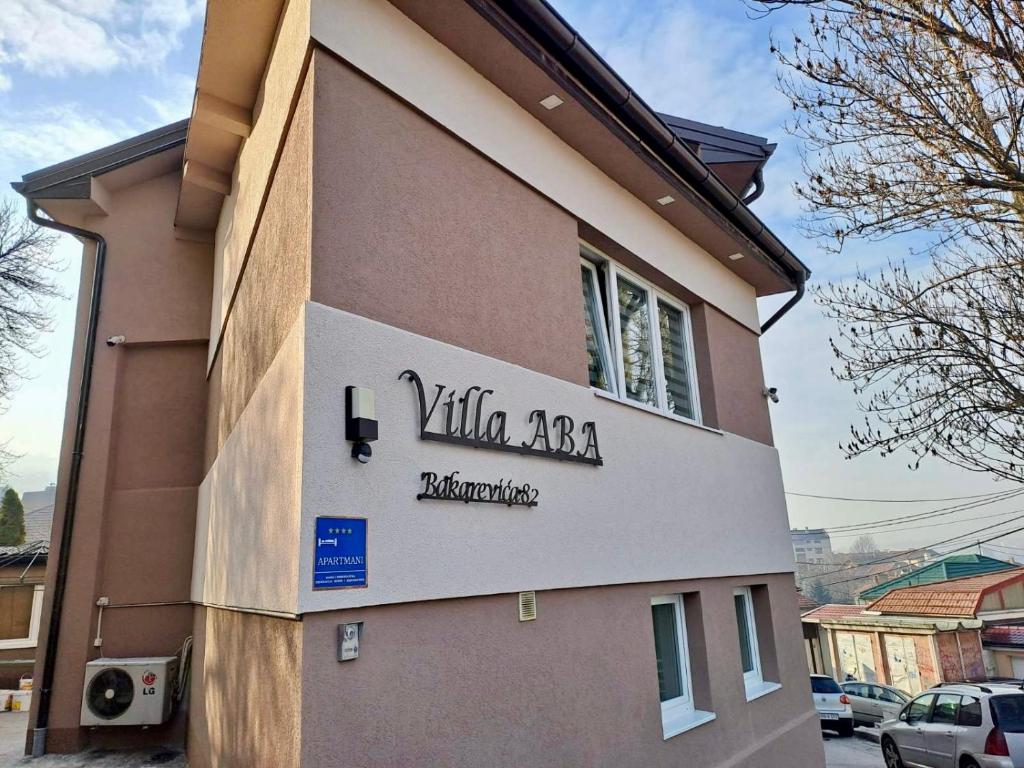 a building with a sign on the side of it at Villa Aba apartments in Sarajevo