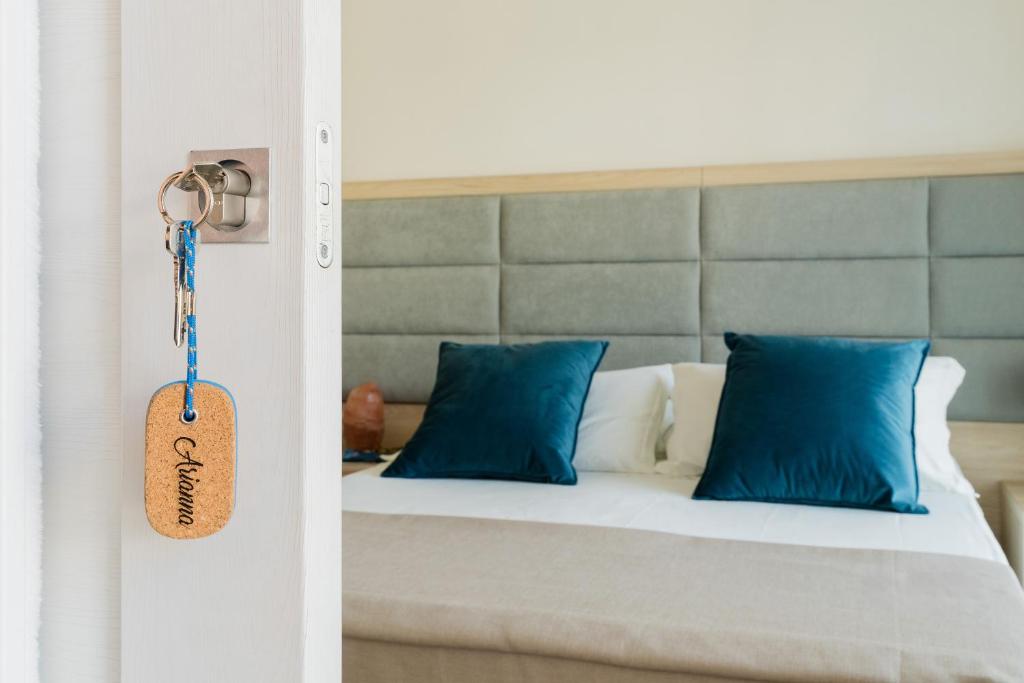 a bedroom with a bed with blue pillows at Baia Di Torre Squillace in Sant'Isidoro