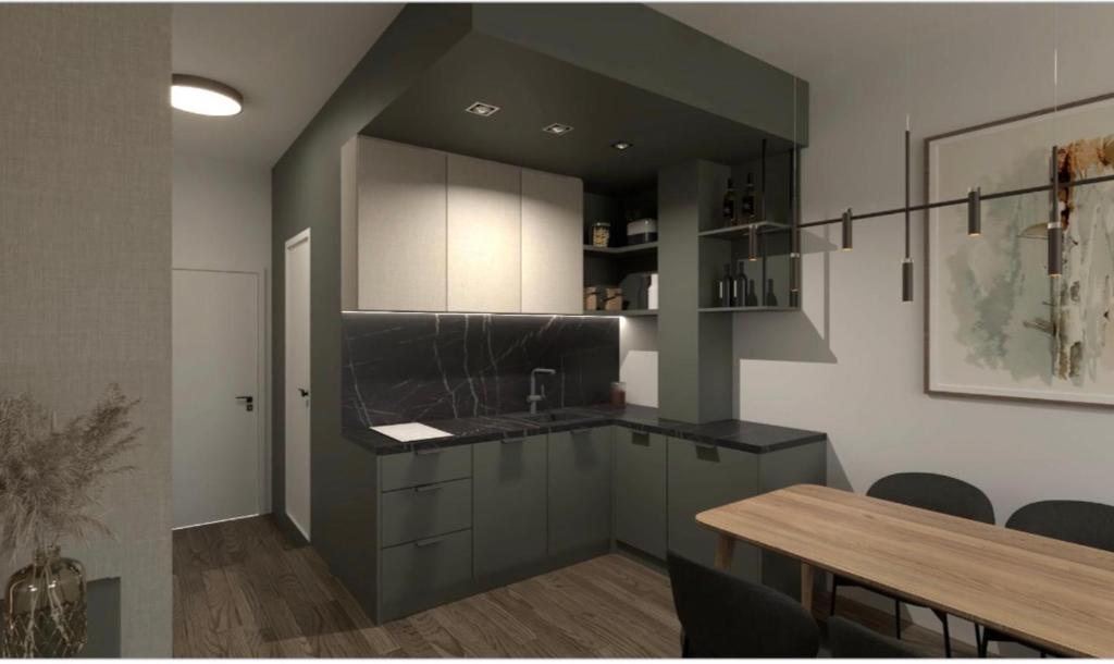 a kitchen with a sink and a table in a room at Tsimiski Central Suites in Thessaloniki