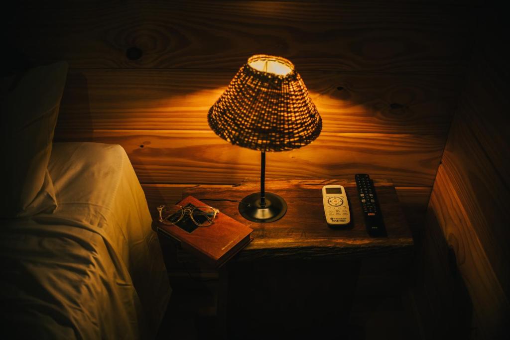 a lamp on a table next to a bed at Irová Apart Hotel in Posadas