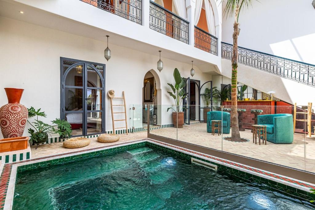a swimming pool in the middle of a house at Traditional Villa Dar Izza - 4 suite with breakfast in Douar Soukkane