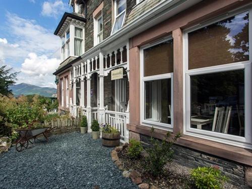 a building with a bench in front of it at Woodside B&B in Keswick
