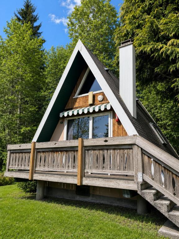 a house with a porch and a deck at Chalet in Le Tholy