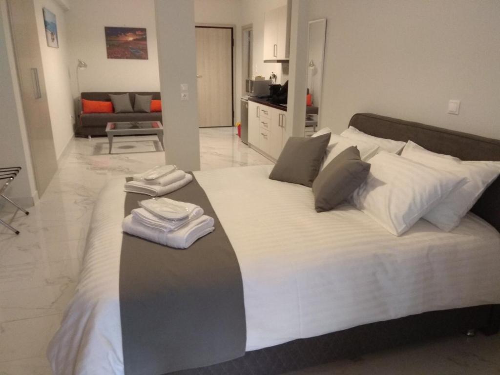 a bedroom with a large bed with towels on it at V17 Syntagma Studio in Athens